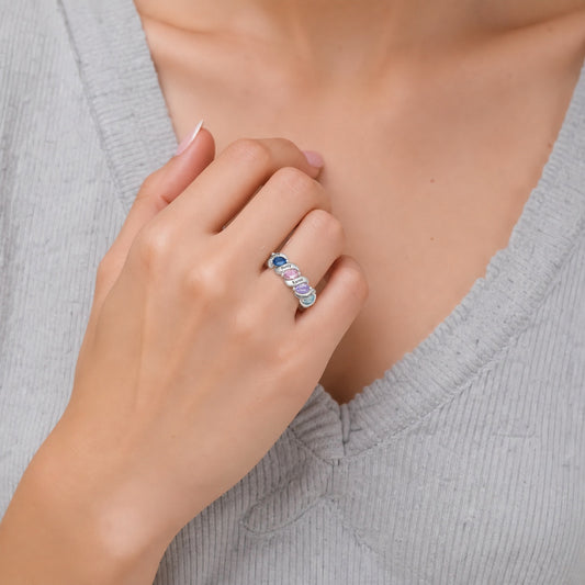 Custom four birthstone family name band ring worn on hand