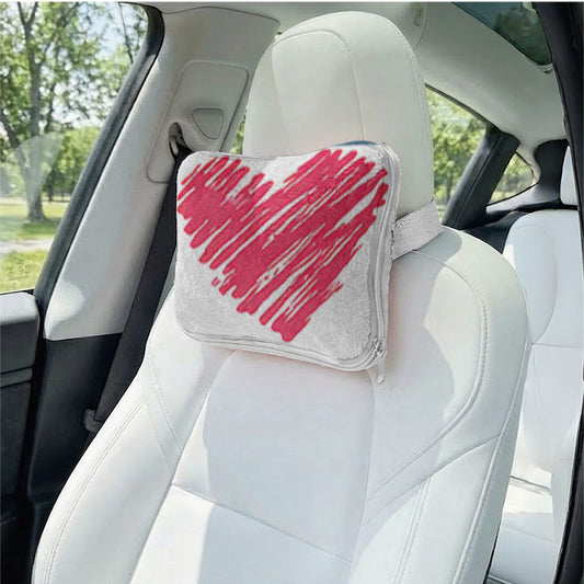 Red heart design pillow used as a car headrest.