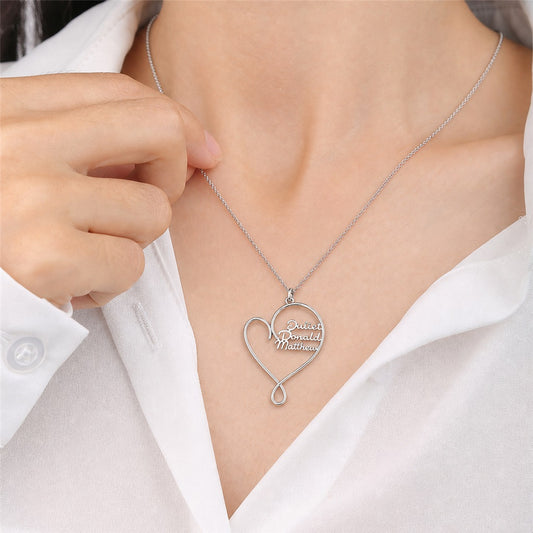 Woman wearing a custom script name heart necklace