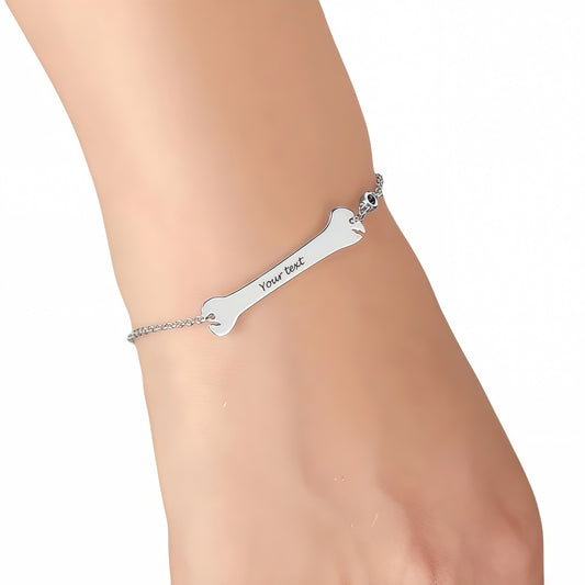 925 Silver custom dog bone bracelet worn on a woman's wrist, pet lover gift.