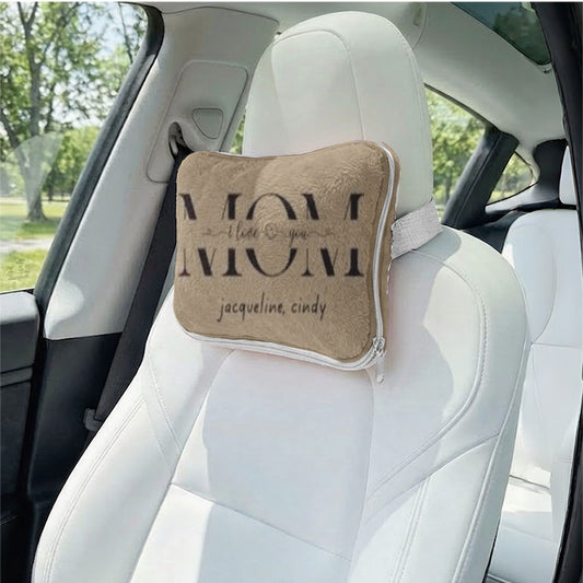 Personalized tan name pillow on a white car headrest
