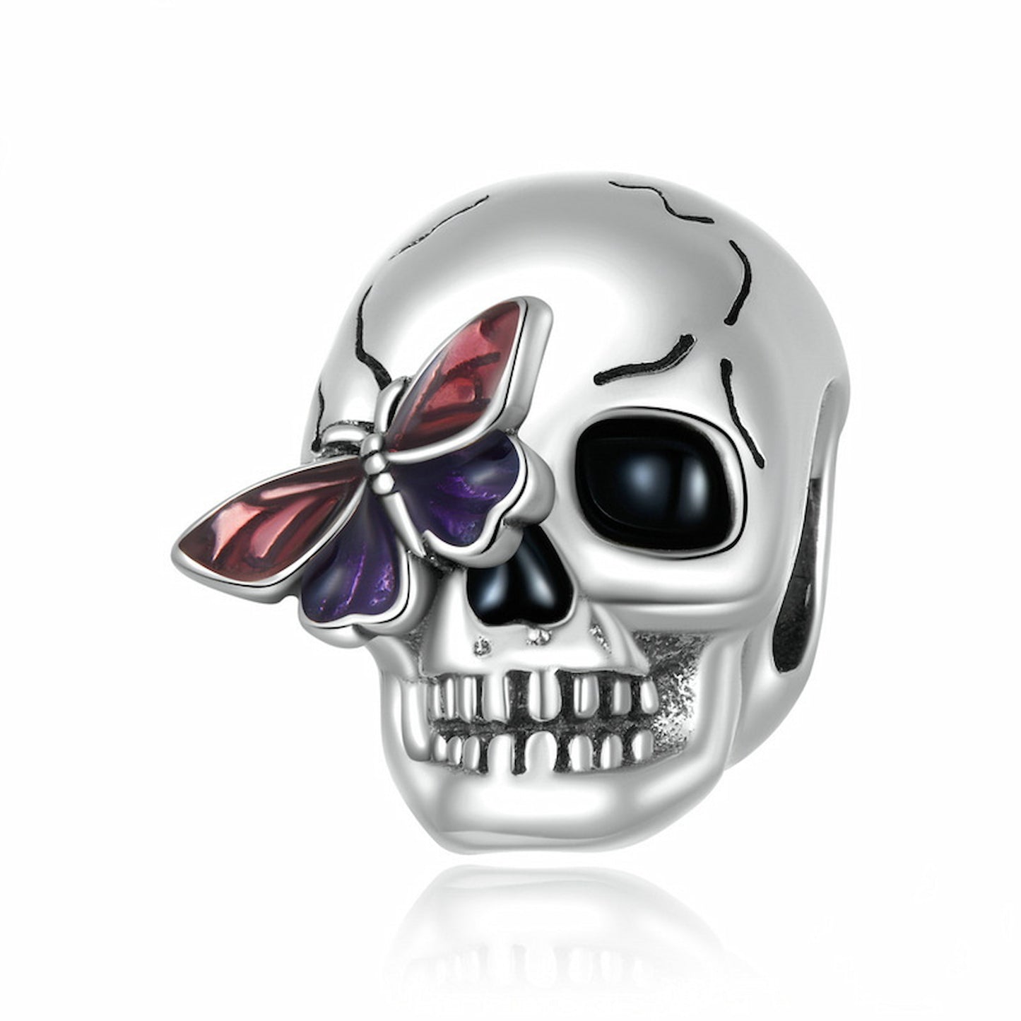 Close-up of personalized sterling silver skull charm with vibrant butterfly detail.