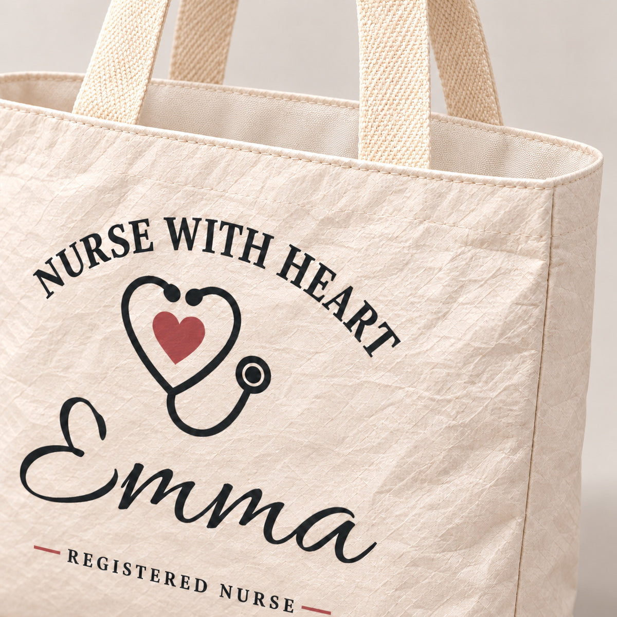 Close-up of the cream Nurse With Heart tote showing its crinkled texture and woven handle.