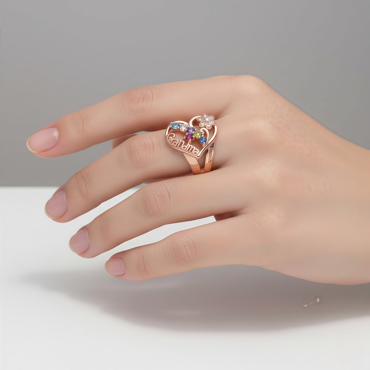 Model wearing personalized rose gold grandma ring with birthstones, perfect gift for grandmothers.