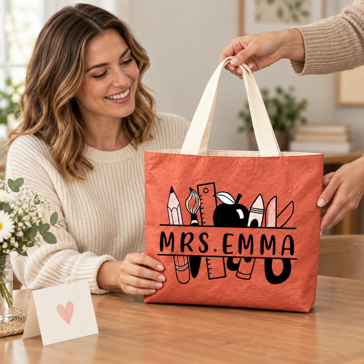 Personalized teacher tote with school supplies artwork and custom name MRS.EMMA, teacher appreciation gift view.
