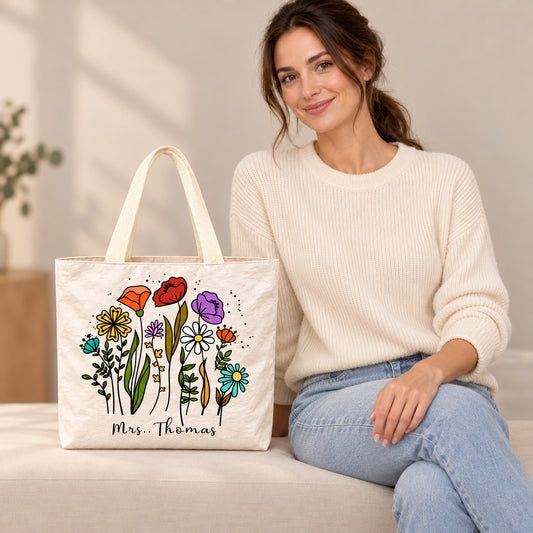 Personalized teacher tote with colorful wildflower artwork and custom name Mrs. Thomas, custom name detail view.