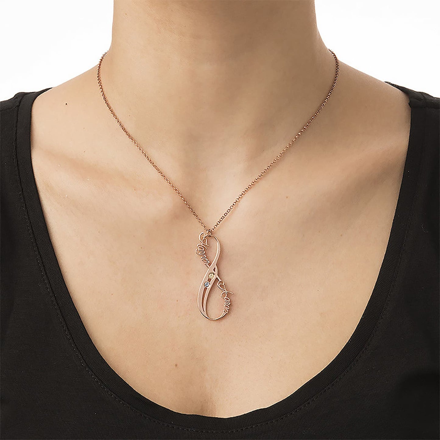 Woman wearing rose gold infinity birthstone name necklace with two custom names.