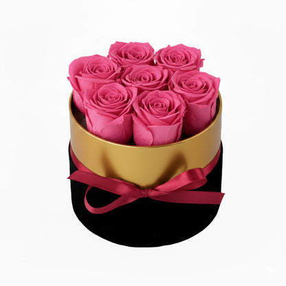 Design luxury 7 pink preserved roses in a black and gold box. Long lasting romantic gift.