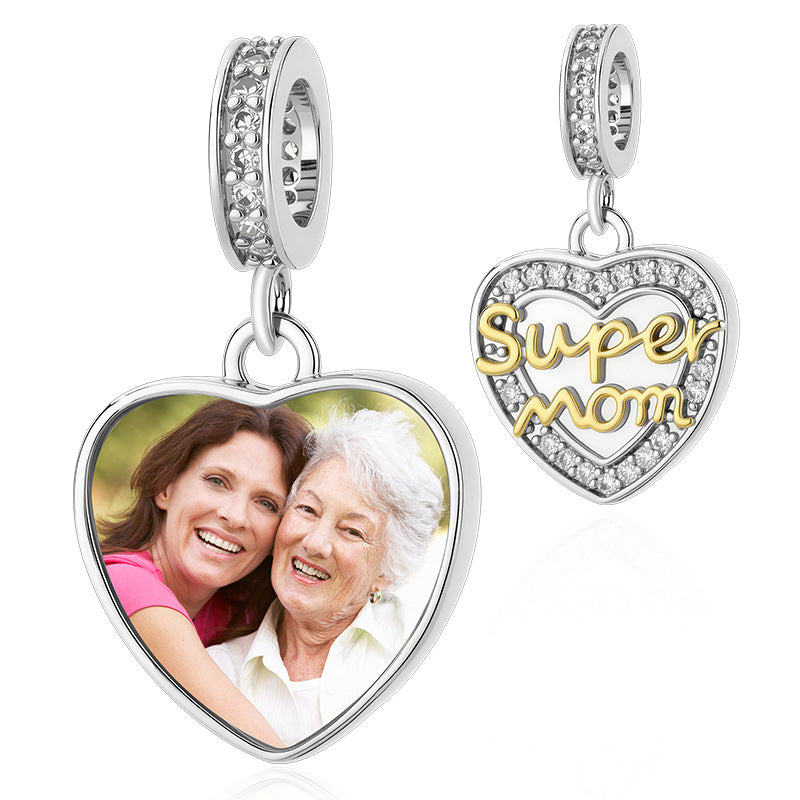 Custom photo heart dangle charm inscribed with "Super mom" in gold script and sparkling pave diamonds.