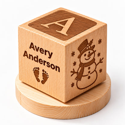 Personalized wooden baby keepsake cube with custom name, baby footprints, snowman engraving, and Baby's First Christmas design