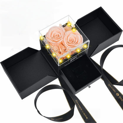Soft champagne peach preserved roses in a romantic LED-lit jewelry gift box.
