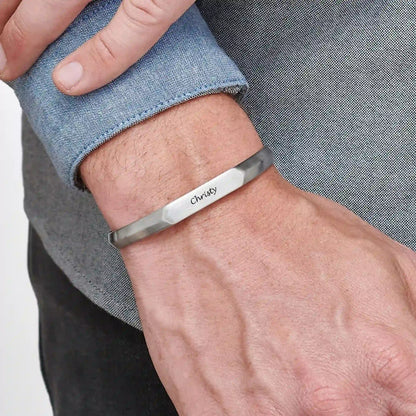 close-up of a man wearing a narrow cuff bracelet