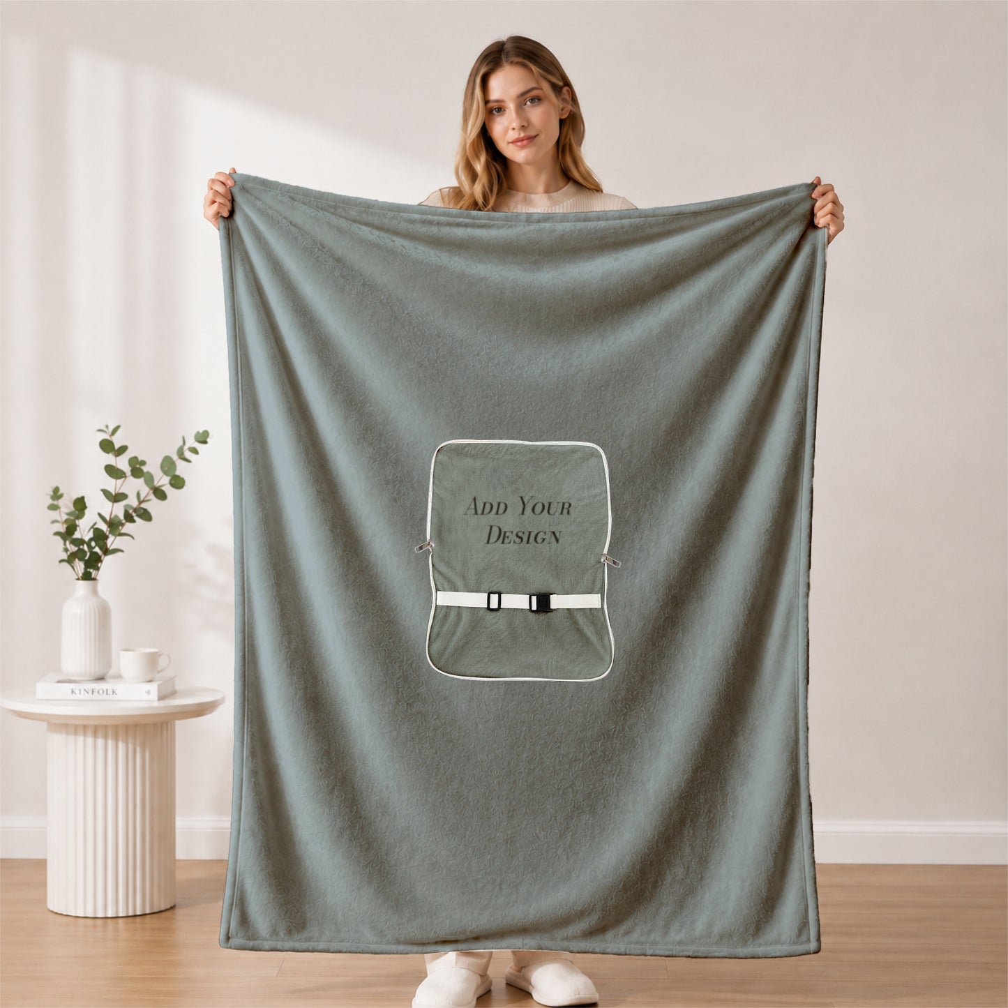 Woman showcasing a large custom-branded corporate blanket.