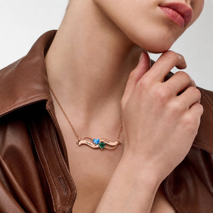 Woman wearing an angel wing birthstone necklace