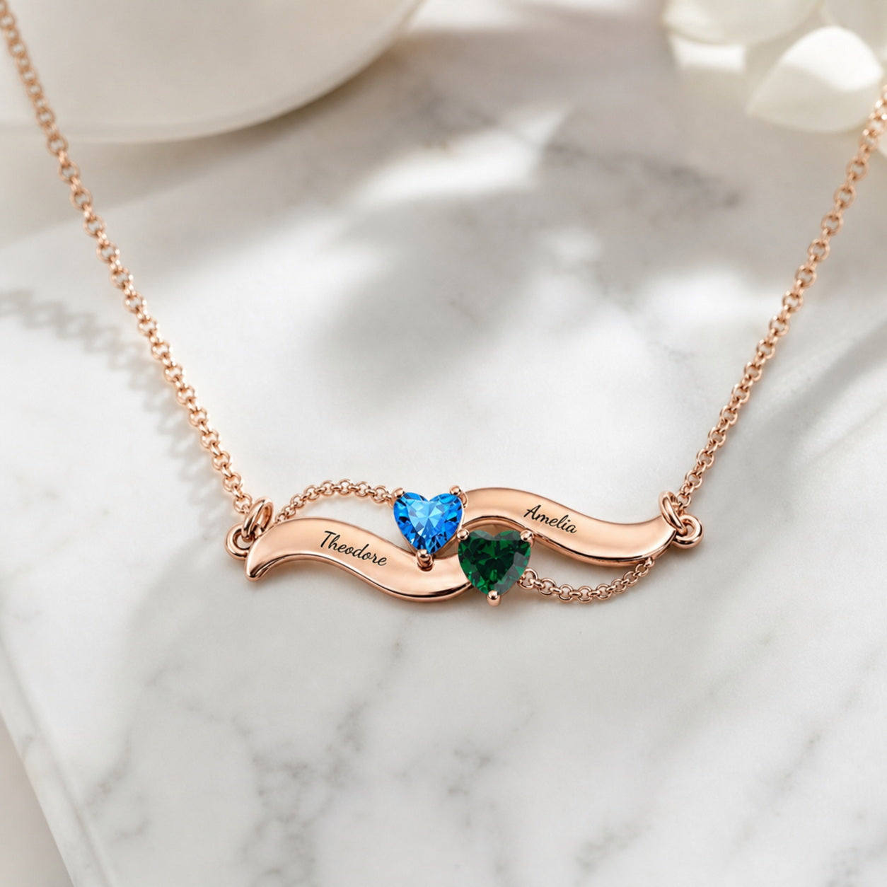 Angel wing birthstone necklace on marble