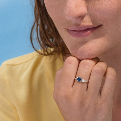 Custom birthstone and pearl open ring worn on hand