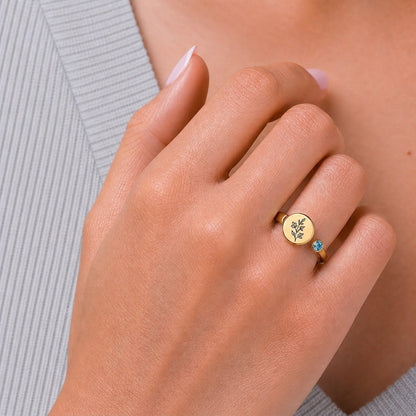Custom botanical disc ring on hand