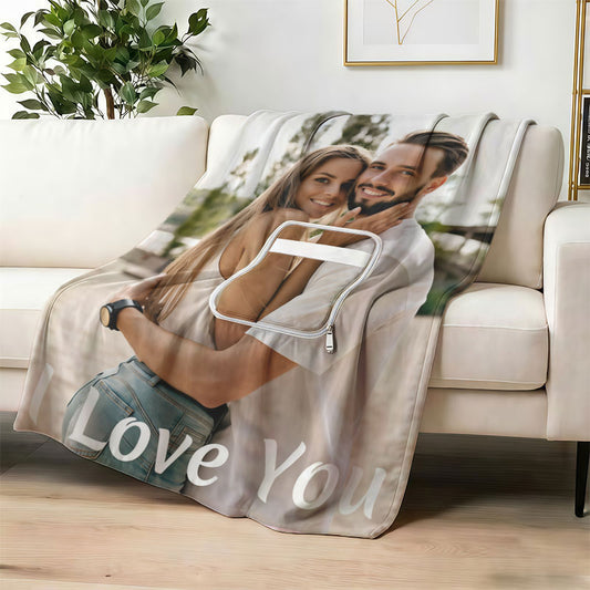 Custom "I Love You" couple photo blanket on a white sofa.