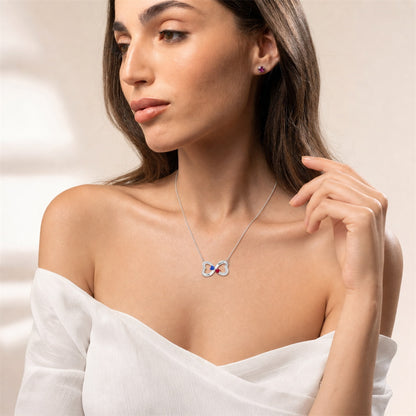 Woman wearing custom double heart birthstone necklace