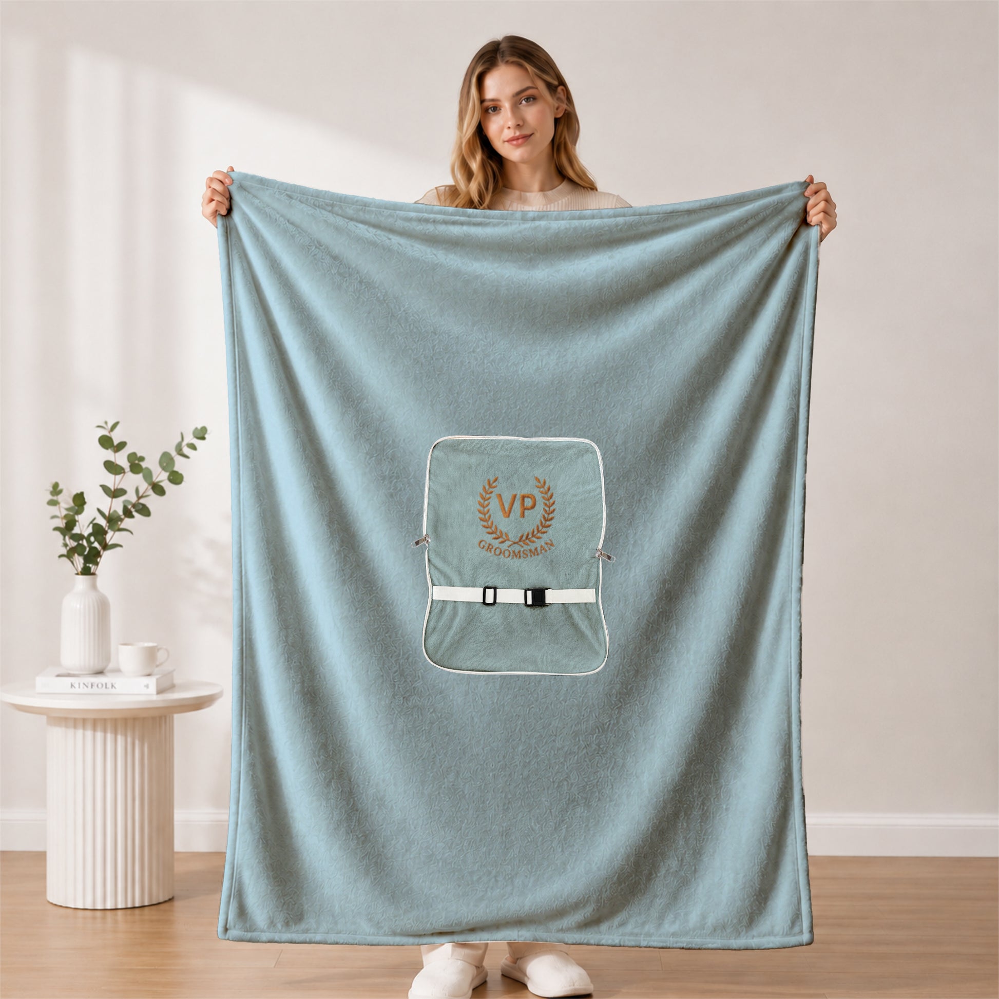 Large plush groomsman blanket held by a woman.