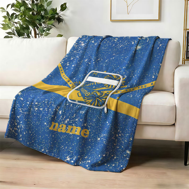 Custom navy fireworks graduation blanket on a sofa.