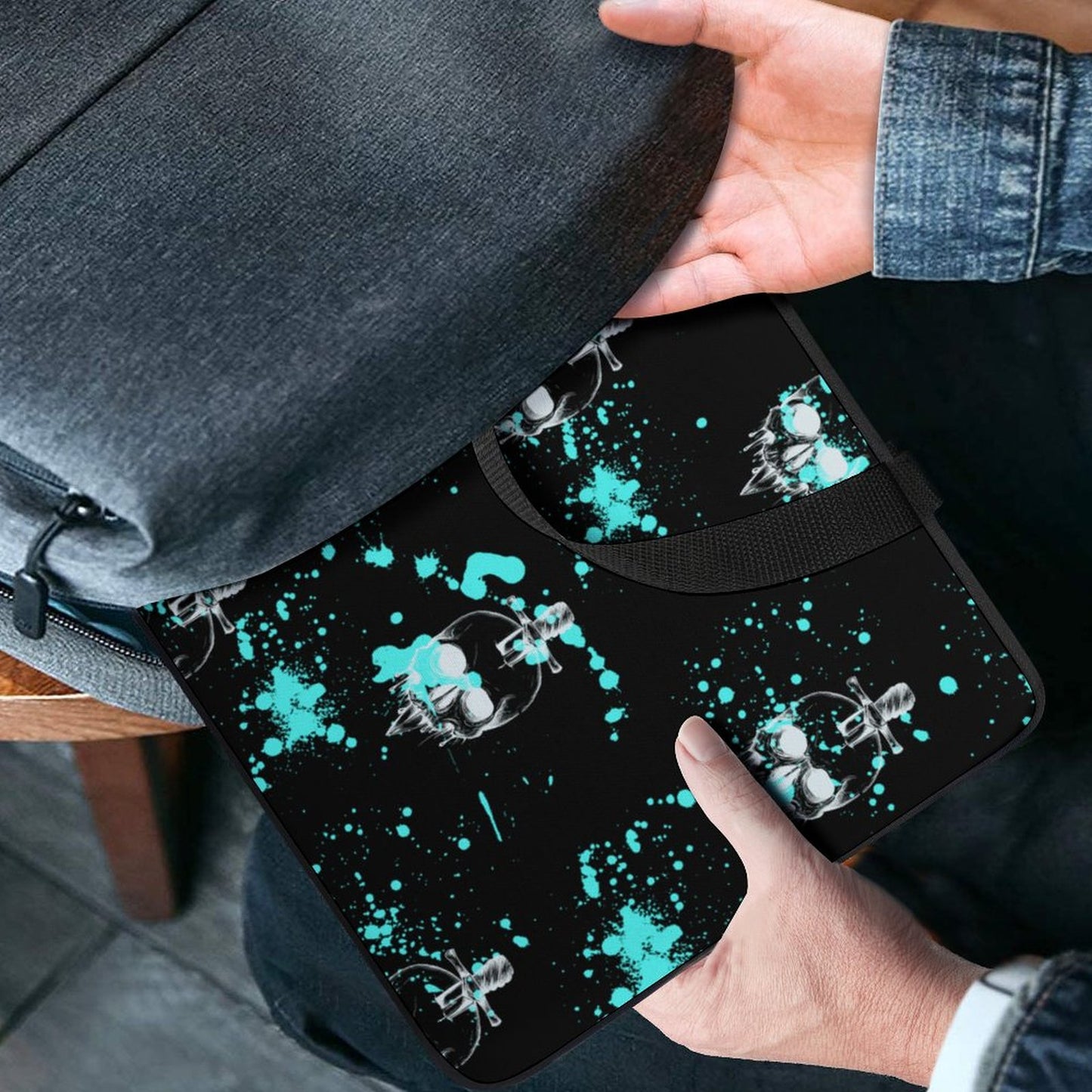 Hand putting the Custom Graphic Laptop Case into a backpack pocket.