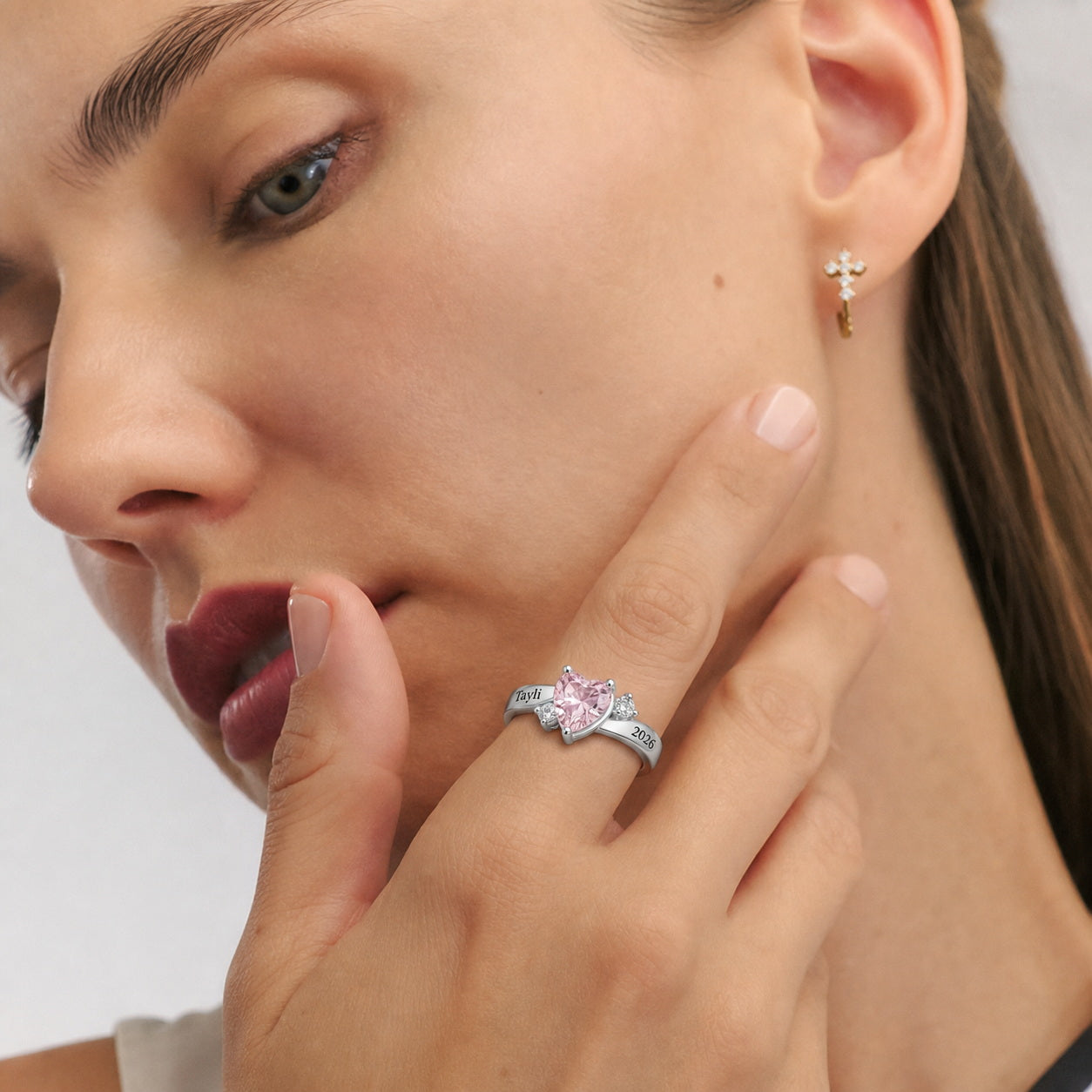 Custom heart birthstone name and date ring worn on hand