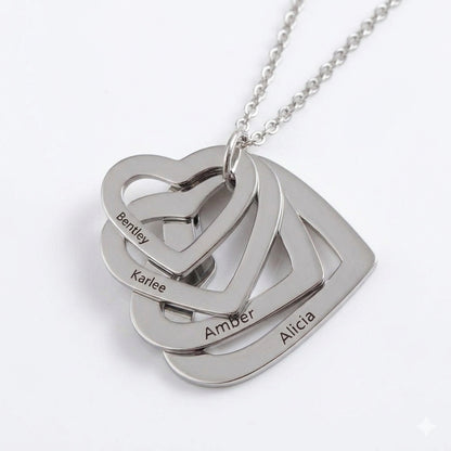 Silver heart necklace with four personalized family names.