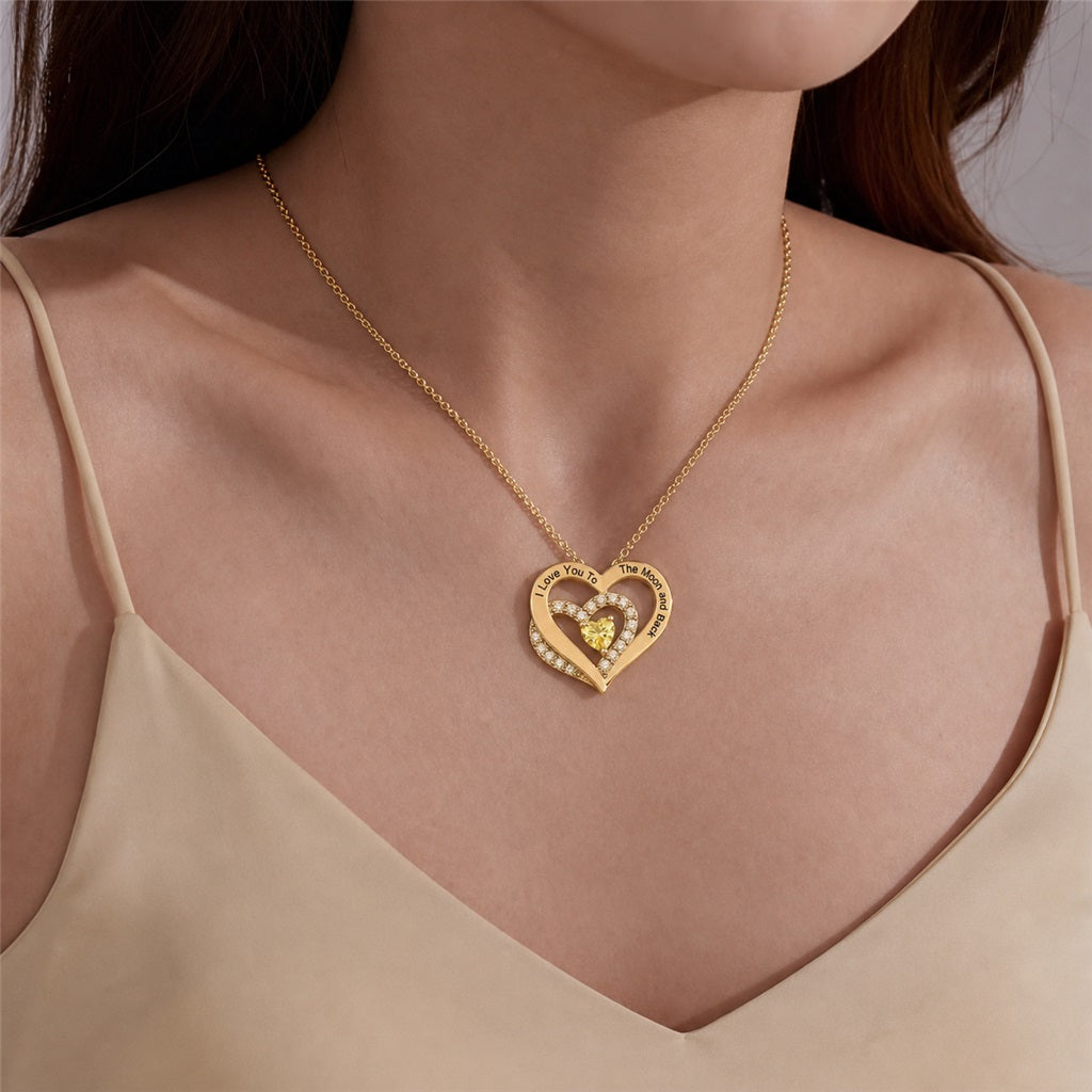 Woman wearing a custom moon and back heart necklace