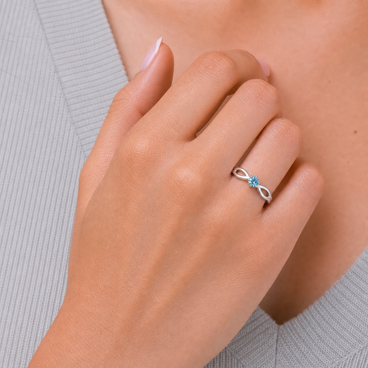Custom infinity birthstone ring on hand