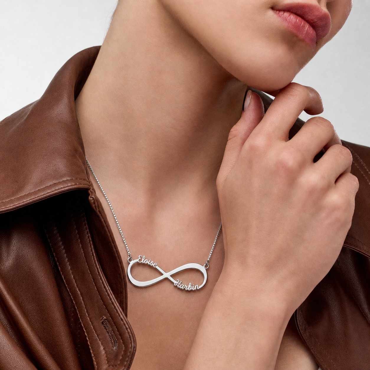 Woman wearing a personalized sterling silver infinity necklace.