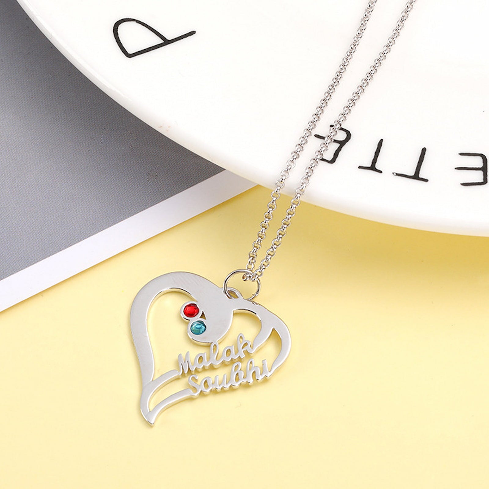 Close up of sterling silver customized jewelry heart necklace gift.