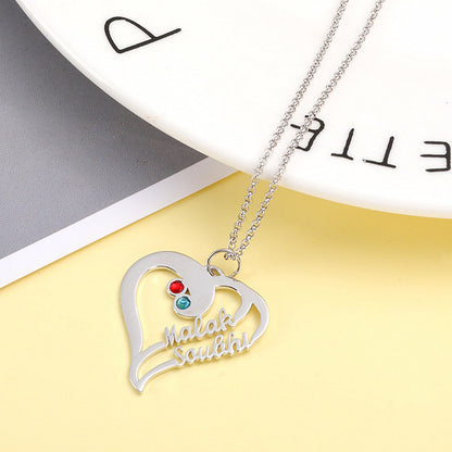 Close up of sterling silver customized jewelry heart necklace gift.