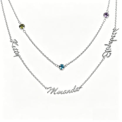 Layered family name necklace on marble