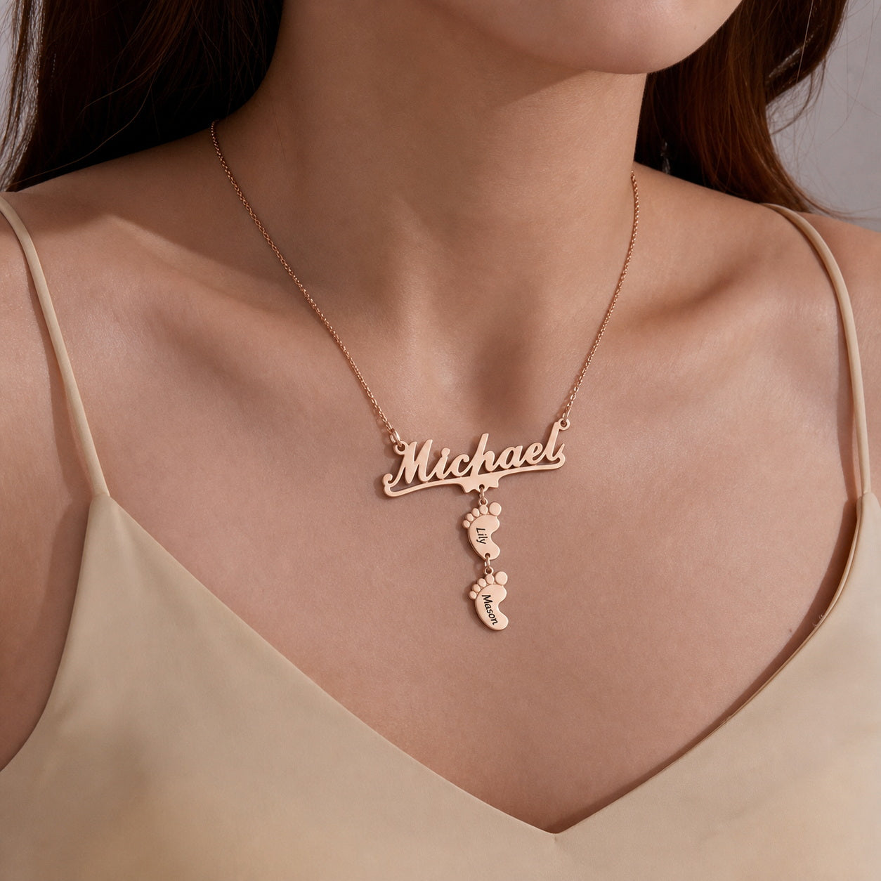 Woman wearing a name baby feet necklace