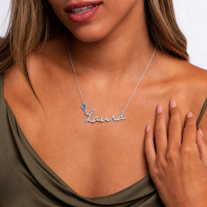 Woman wearing a name birthstone necklace