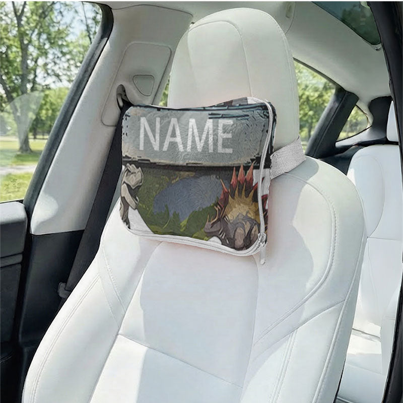 Personalized dinosaur pillow used as a car headrest.