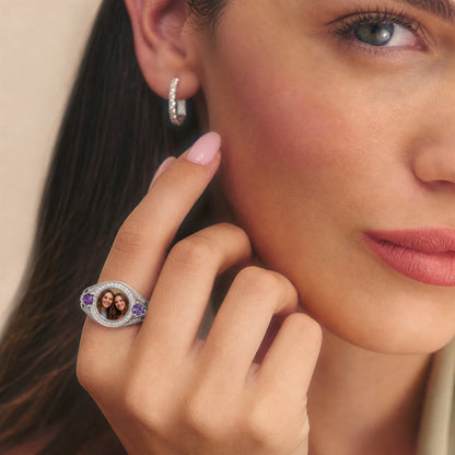 Custom photo halo ring with two birthstone accents worn on h