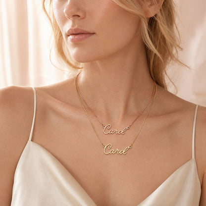 Model wearing two custom script nameplate necklaces.