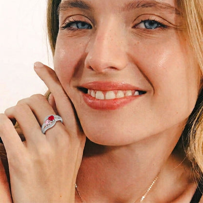 Custom two birthstone heart bypass ring worn on hand
