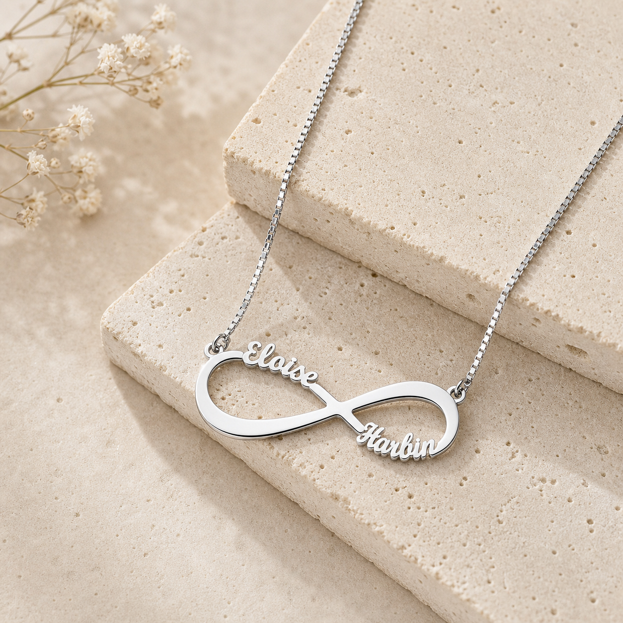 Sterling silver infinity loop pendant with custom family names.