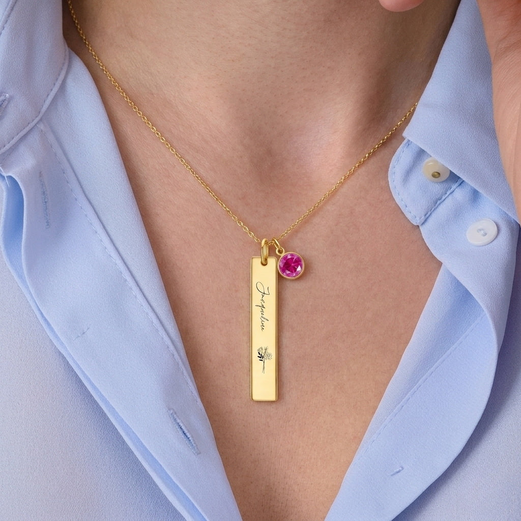 Woman wearing a dainty gold vertical birth flower necklace.