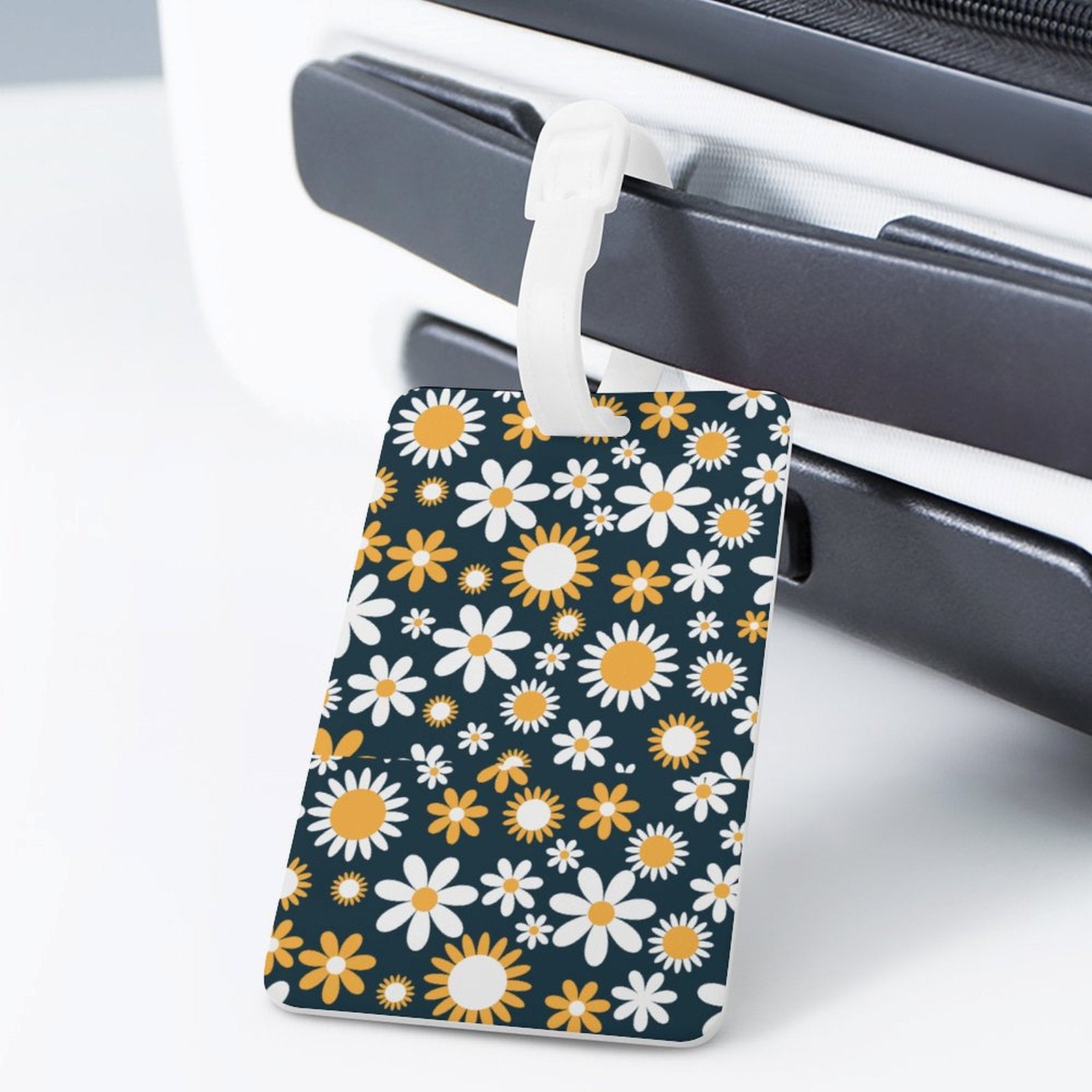 Custom Daisy Luggage Tag secured to suitcase handle.