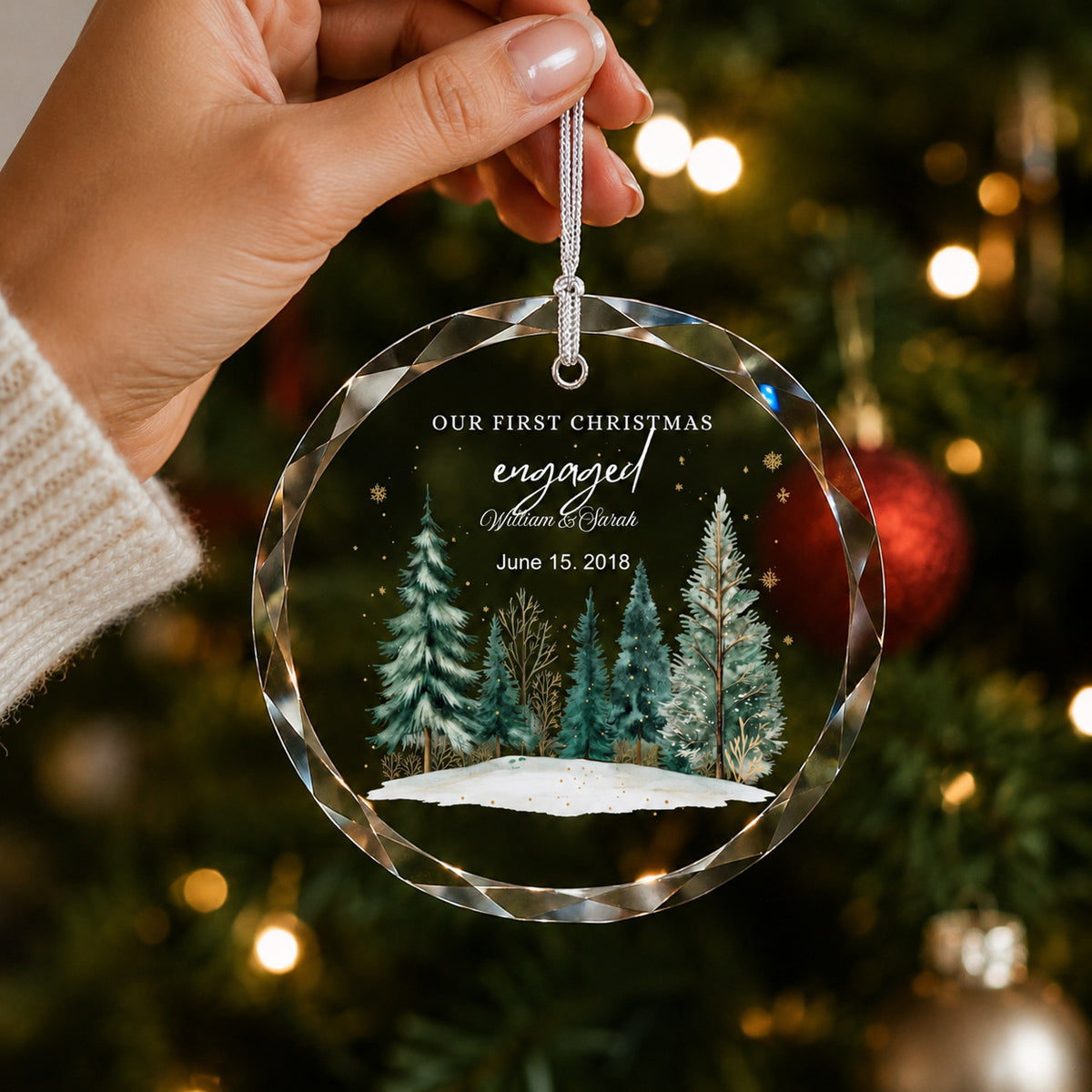 Our First Christmas Engaged Winter Forest Design personalized glass ornament in hand scale view