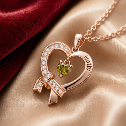 Engraved heart ribbon necklace closeup on champagne silk