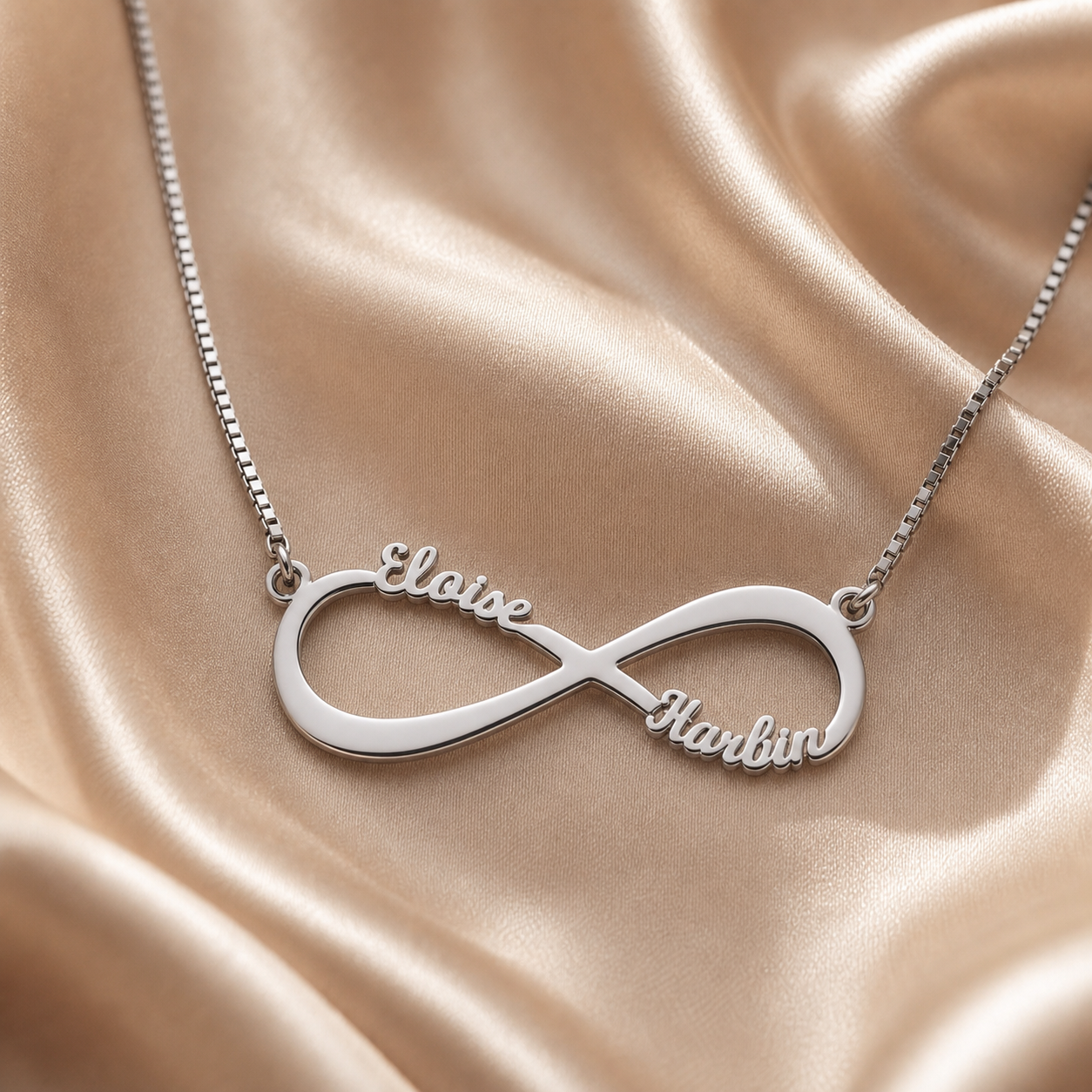 Sterling silver infinity necklace with two engraved names.
