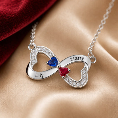 Engraved two name infinity necklace closeup on silk