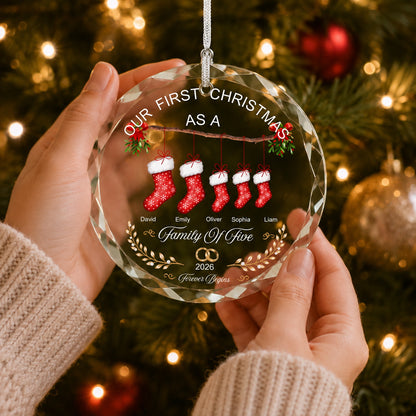 Personalized family Christmas ornament held by hands in front of a cozy Christmas tree with warm holiday lights