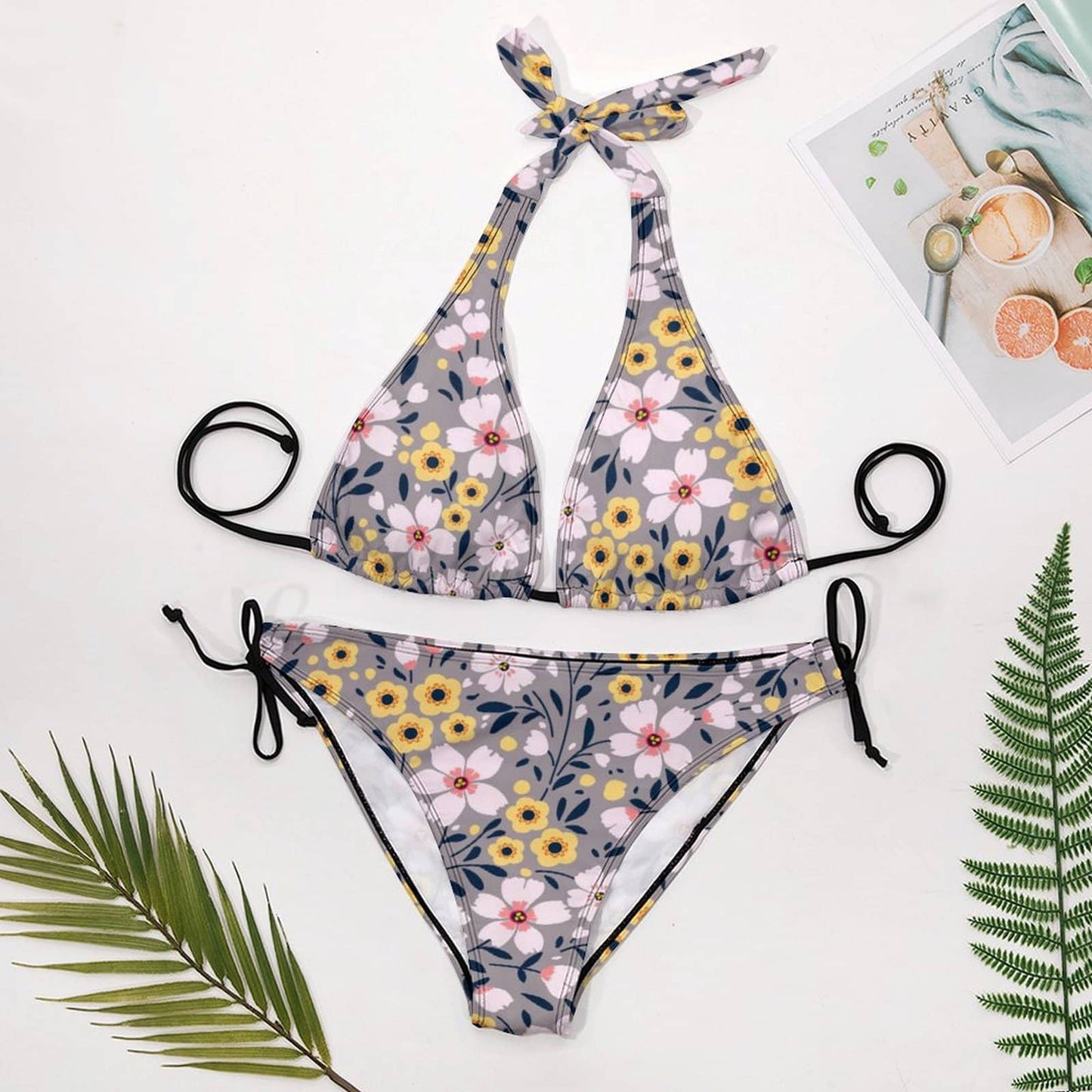 Flat lay of Halter Bikini Set and Side Tie Bottoms. Shows the Triangle style and all-over floral print.
