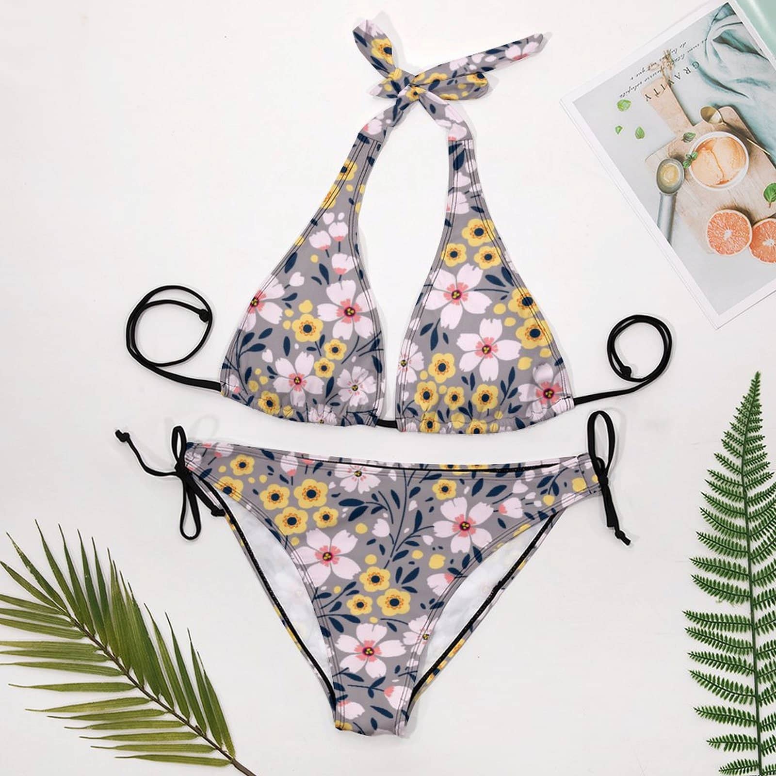 Flat lay of Halter Bikini Set and Side Tie Bottoms. Shows the Triangle style and all-over floral print.